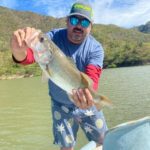 angler Fidel Vidal showing off a largemouth bass at Lake Aguamilpa, Tepic, Nayarit